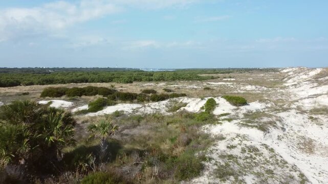 Aerial flyover of Anastasia State park, beaches and sand dunes along the coast of Florida.