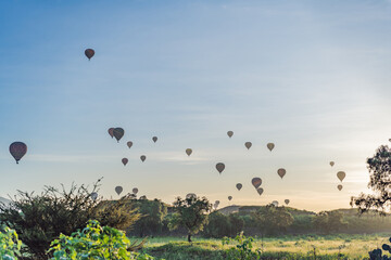Colorful hot air balloons floating over Teotihuacan in Mexico, creating a breathtaking view of the ancient pyramids. Tourism, adventure, and cultural heritage concept