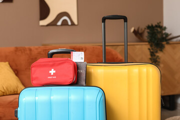 Suitcases with first aid kit and passport in room