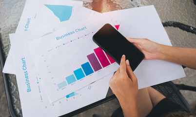 Business chart smartphone hands person data analysis office desk technology business report graph communication digital device casual modern work statistics paper table casual clothing business