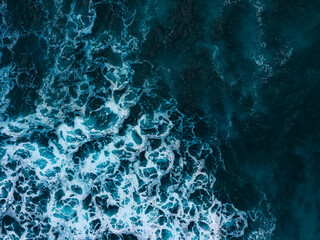 Water ocean waves texture background, aerial top down view. Surface of Atlantic ocean wave splash and foam