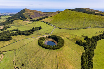 Round lake Pau Pique in lush volcanic crater, Azores islands, Portugal. Aerial view