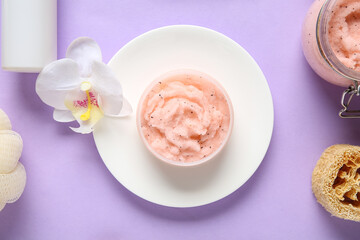 Plate with jar of natural body scrub and orchid flower on lilac background