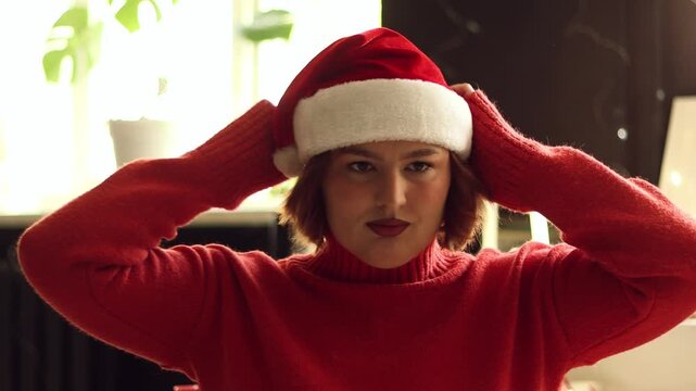 Christmas, face and woman in satnas hat at home, cheering and celebration. Xmas, tradition and person with happiness, festive season and smile with culture, holiday and dance with good news