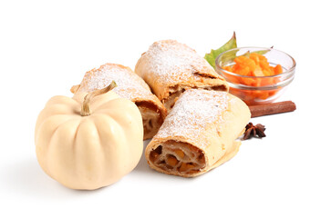 Pieces of tasty pumpkin strudel with cinnamon and star anise on white background