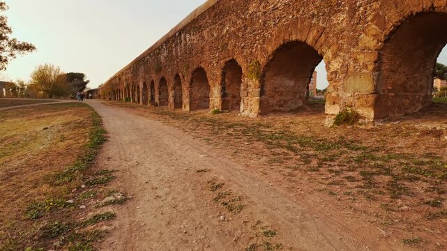 The sun sets on the Park of the Aqueducts or Parco degli Acquedotti in Rome, Italy