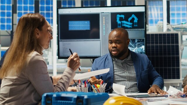 Factory manager presents business models to investors, highlighting innovative strategies for expanding production. Shareholders discuss integrating automation technology in industrial plant, camera B