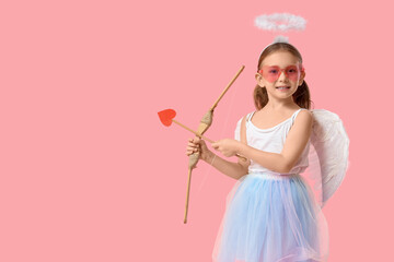 Obraz premium Cute little girl dressed as Cupid with arrow and bow on pink background. Valentine's Day celebration