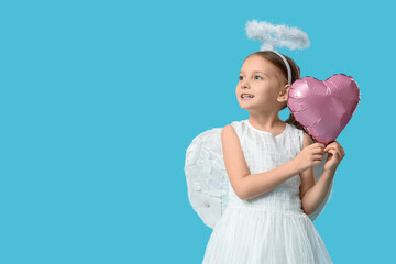 Obraz premium Cute little girl dressed as Cupid with air balloon in shape of heart on blue background. Valentine's Day celebration