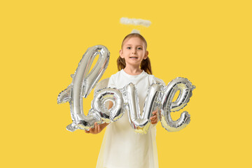 Obraz premium Cute little girl dressed as Cupid with air balloons in shape of word LOVE on yellow background. Valentine's Day celebration