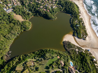 Aerial view of lake, forest and beach