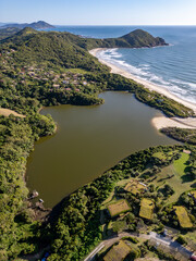 Aerial view of lake, forest and beach