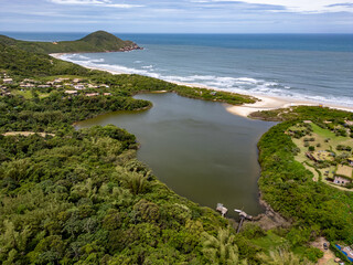 Aerial view of lake, forest and beach