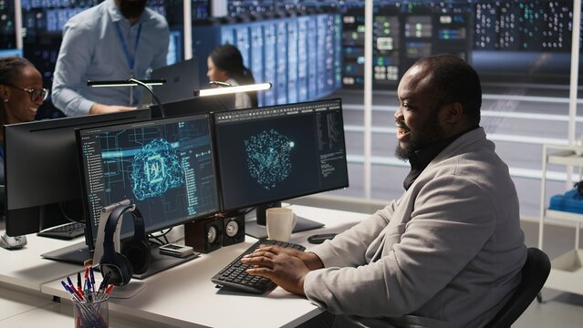 Data center system administrator monitoring servers gear performing AI training and inference tasks. Man working in server room oversees computing systems, managing deep learning operations, camera A