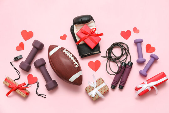 Composition with different sports equipment, gifts and paper hearts on pink background. Valentine's Day celebration - Powered by Adobe