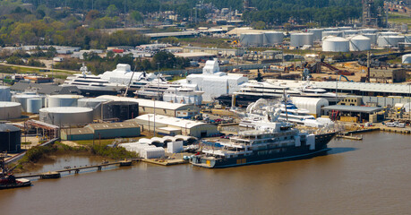 Large luxury yacht under construction in shipyard with cranes. Assembly of sea vessel