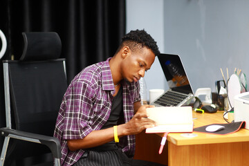 young guy using notepad and smartphone