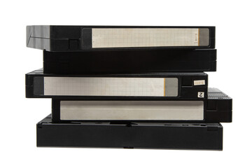 A stack of black VHS video tapes with blank labels on a white back