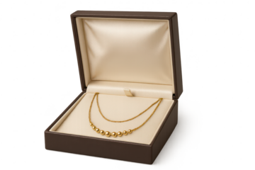 Elegant golden beaded necklace in open jewelry box, transparent background