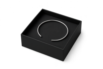 Silver cuff bracelet in a black box, isolated on transparent background.
