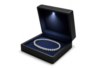 Exquisite diamond bracelet in a lit jewelry box, isolated on transparent background.