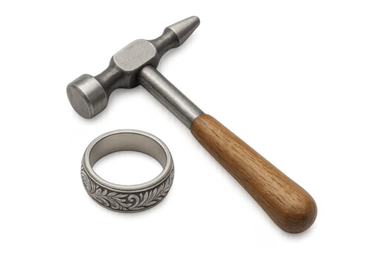 Jeweler's hammer and engraved ring isolated on transparent background.
