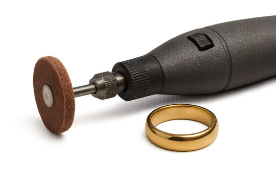 Small rotary polishing tool and gold ring isolated on transparent background