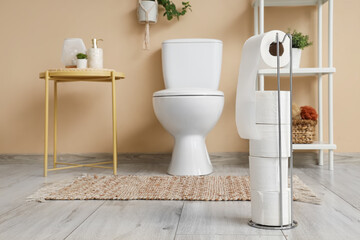 Holder with toilet paper rolls in restroom