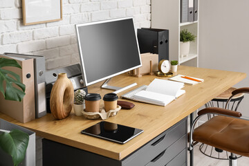 Workplace with computer and book in modern office