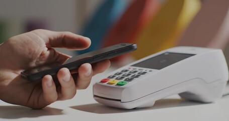 Close up of mobile contactless payment via smartphone in modern retail store. - Powered by Adobe