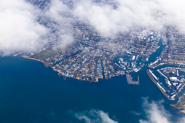 View from above of an airplane flying over the coast of North America.