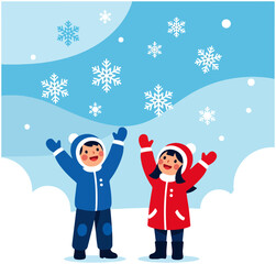 Two happy children playing outdoors in the snow with falling snowflakes.