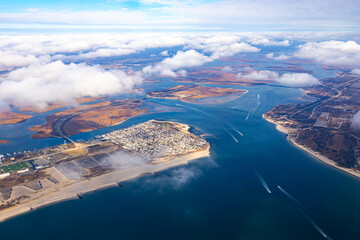 View from above of an airplane flying over the coast of North America.