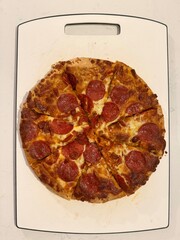 Classic Pepperoni Pizza: Freshly baked Italian pizza topped with melted mozzarella cheese and spicy pepperoni slices.