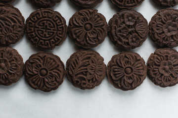 Overhead view of stamped chocolate cookies on a parchment lined baking tray