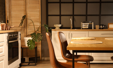 Dining table with chairs in kitchen at night