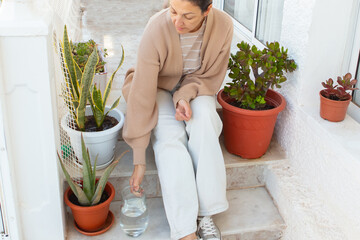 Caring for indoor plants with love and attention in a cozy home setting