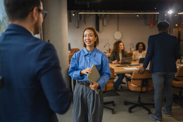Business professionals having a conversation in a modern office