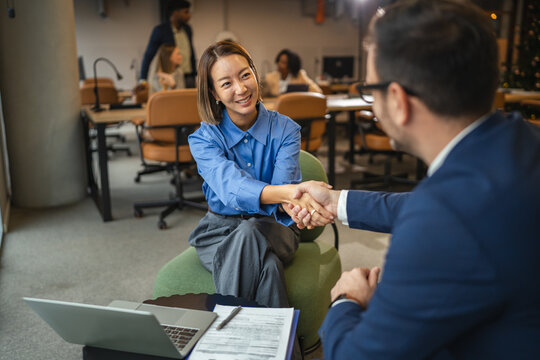 Businesswoman and businessman shaking hands making an agreement