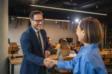 Smiling business colleagues enjoying a casual conversation in the office
