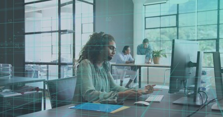 Typing office worker in light green blouse checking tablet and monitor at office desk, with overlay