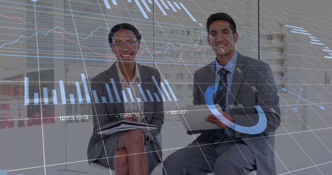 Smiling colleagues in suits reviewing data overlays in meeting area, with tablet and notepad - Powered by Adobe