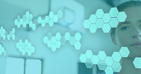 Studying woman on right in light top viewing floating hexagon holo tiles in clinic, copy space