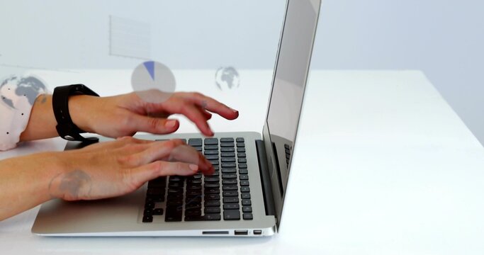 Typing female hands on silver laptop at white desk, wearing dotted shirt, smartwatch, data overlays - Powered by Adobe