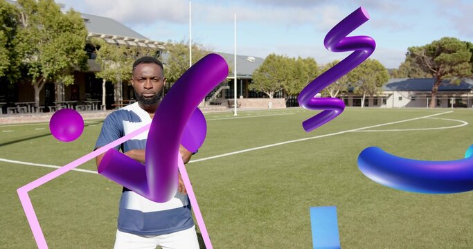 Standing man wearing blue jersey and white shorts on pitch, showing goalposts and 3D shapes - Powered by Adobe