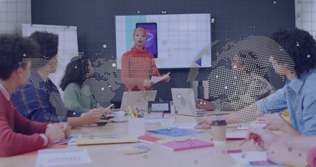 Presenting red-sweater leader addressing team at conference room with display showing smartphone