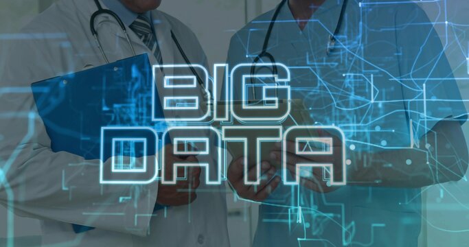 Standing two MDs consulting BIG DATA overlay in clinic, lab coat and scrubs, tablet, stethoscopes
