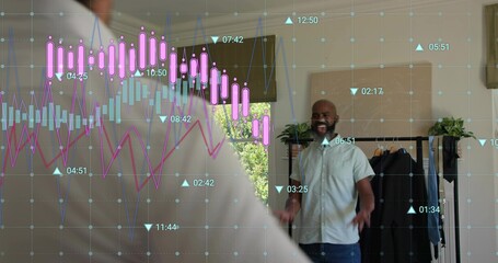 Smiling man wearing short sleeve shirt, jeans gesturing in home studio, with rack charts copy space