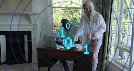 Reviewing senior woman and mature man sharing laptop and papers at home office, with blue overlay