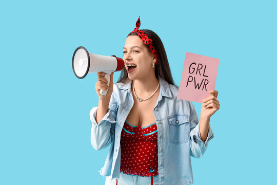 Young pin-up woman with GRL PWR sign and megaphone on blue background. Women's History Month